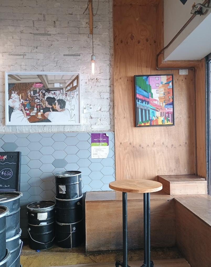 Inside Little Bishop — exposed brick, local art, pendant lighting